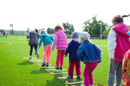 Child climbing during gross motor coordination therapy at pediatric OT clinic